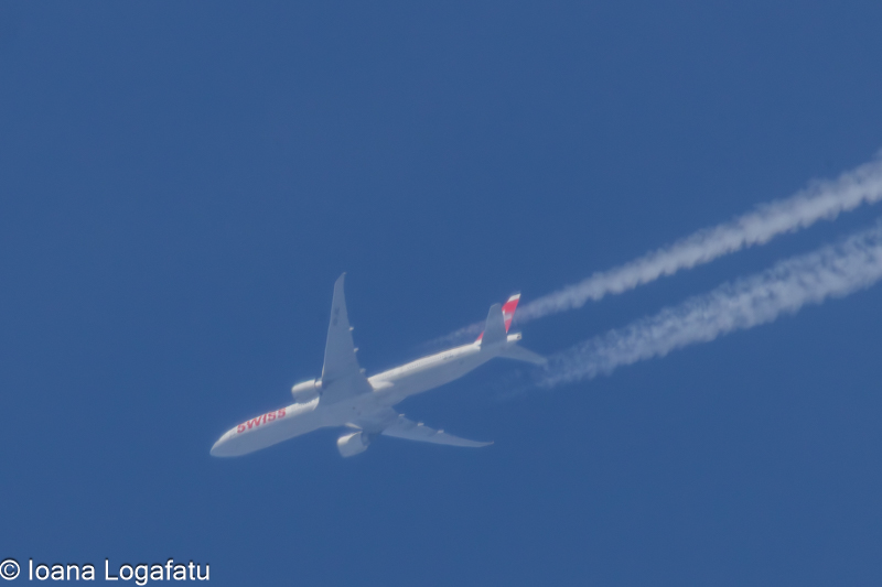 Elegant aircraft soars high in a clear blue sky